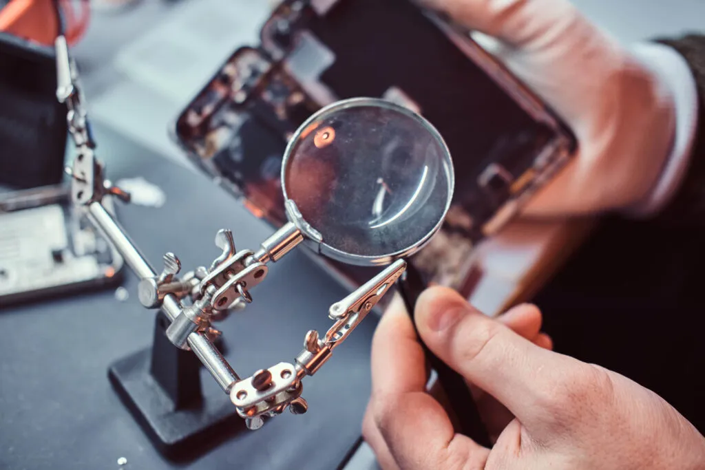 Technician inspecting the internal parts of a device